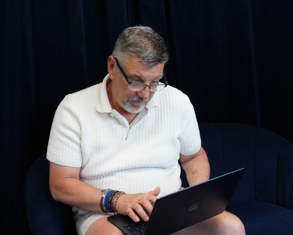 Owner and Managing Director Dave Davis on laptop